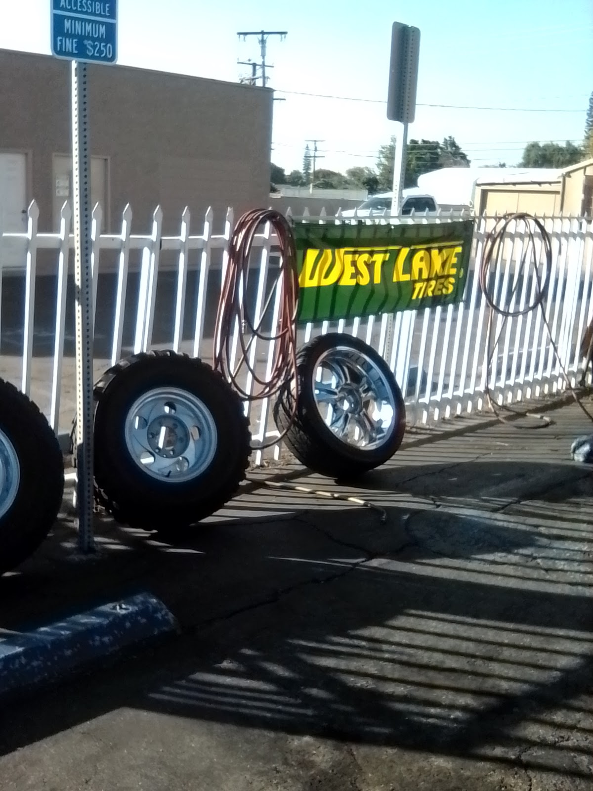 Wheels and tires lined up along the front fence